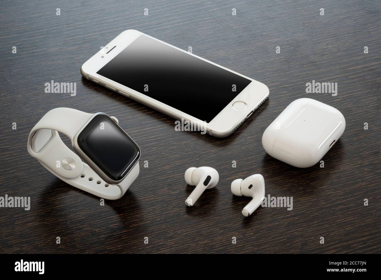 Izmir, Turquie - 7 août 2020 : gros plan de l'iPhone 8 blanc, de l'Apple Watch 5 et de l'Air Pods pro sur un sol en bois. Banque D'Images