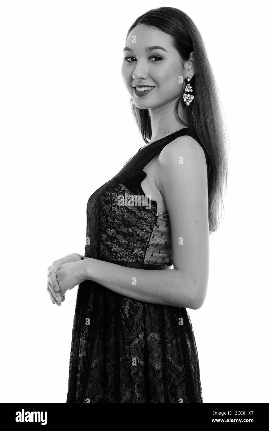 Studio shot of young happy Asian woman smiling with hands together Banque D'Images