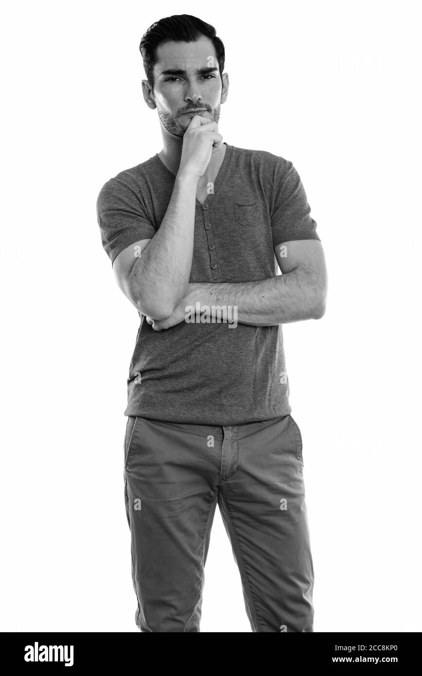 Studio shot of young handsome man standing en pensant Banque D'Images Studio shot of young handsome man standing en pensant Banque D'Images