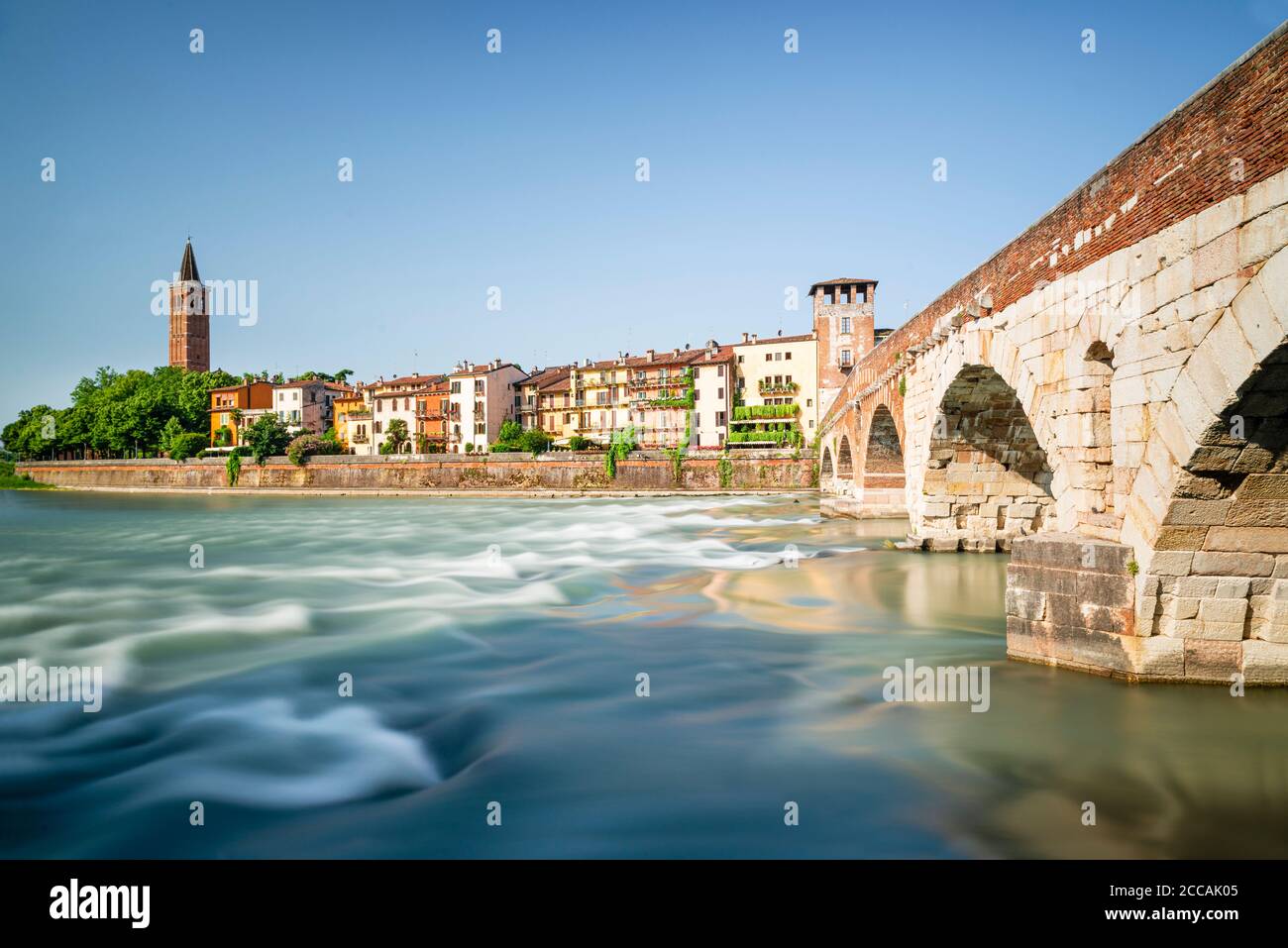 Le pont romain Ponte Pietra en pierre au-dessus de la rivière Adige avec le panorama de la vieille ville de Vérone au soleil du matin, Vénétie, Italie Banque D'Images