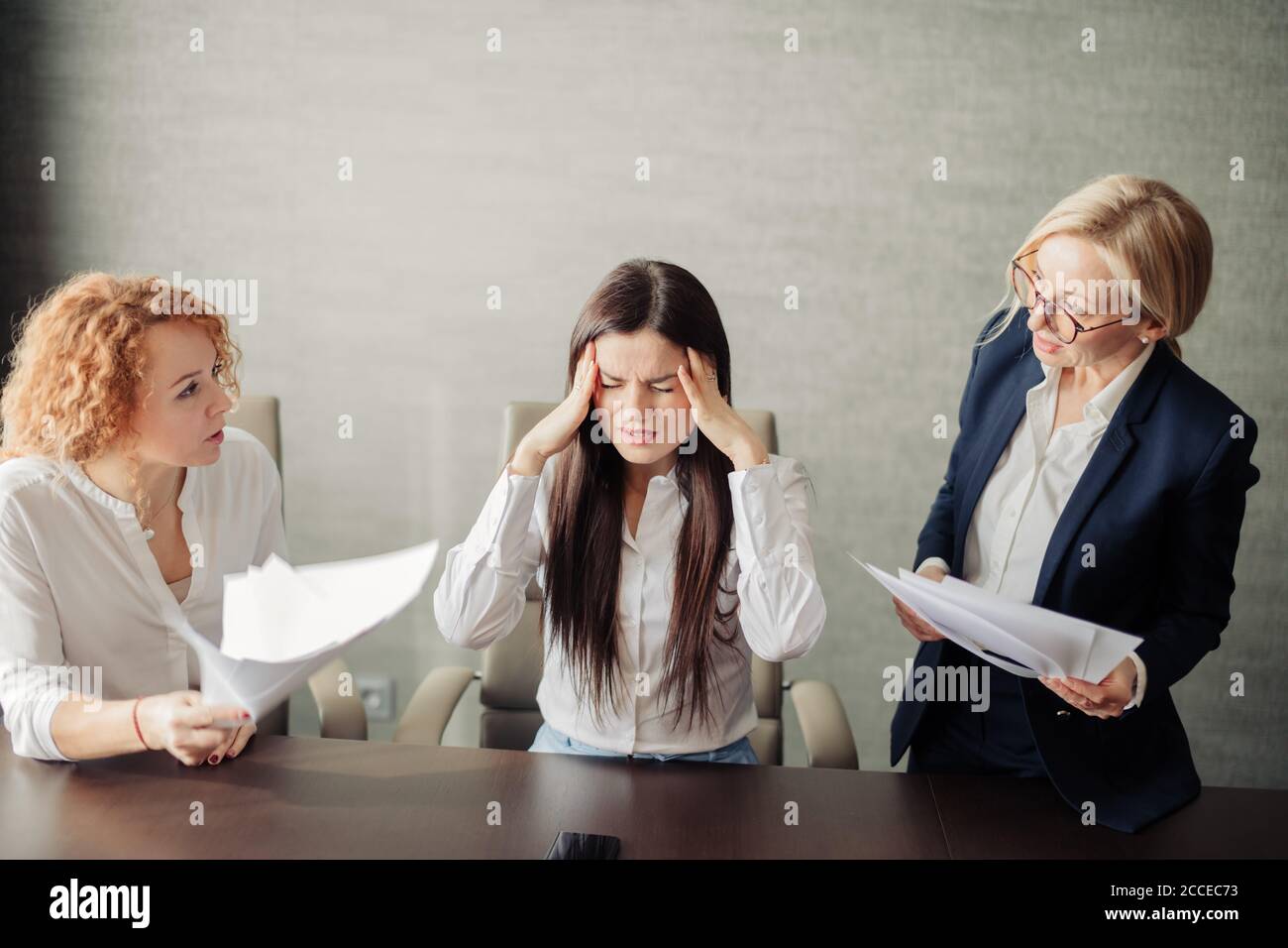 Femme fatiguée frustrée, assistante féminine aux yeux fermés, gardant les paumes près des temples, se sent nerveux en cas de travail excessif et de multitâche. Elle Banque D'Images