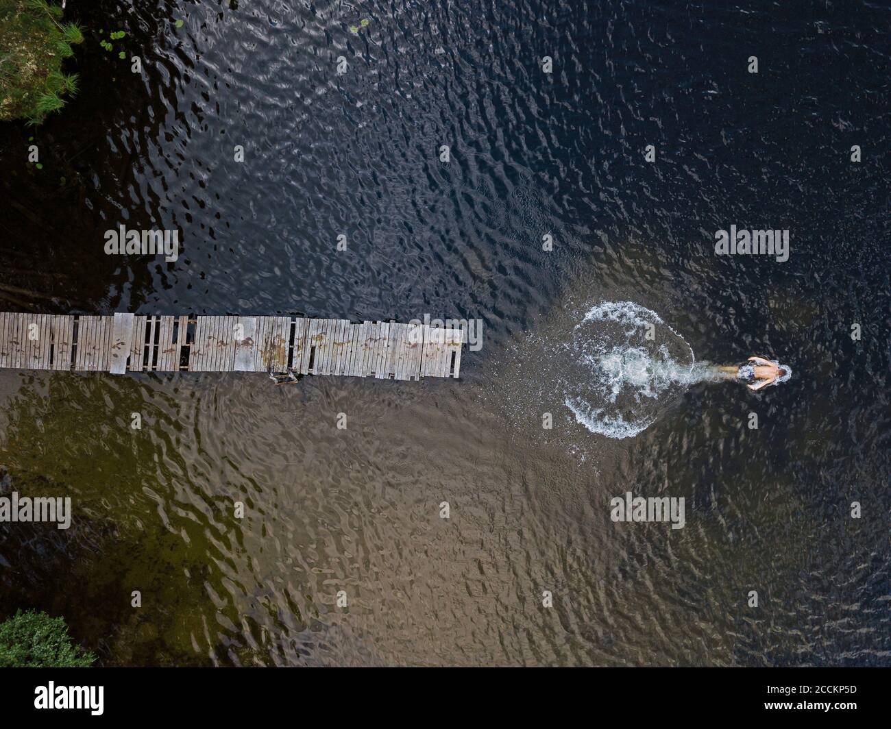 Vue aérienne d'un jeune homme nageant dans le lac Banque D'Images