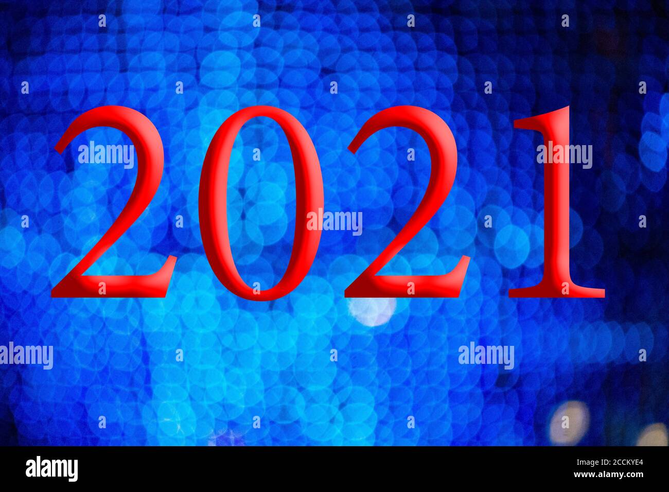 Texte avec le numéro d'année 2021 avec un arrière-plan de lumières bleu clair hors de la mise au point avec effet bokeh. Bonne année 2021. Banque D'Images