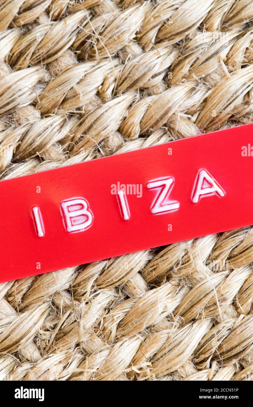 Étiquette rouge en relief avec les mots Ibiza sur une paille arrière-plan tissé Banque D'Images