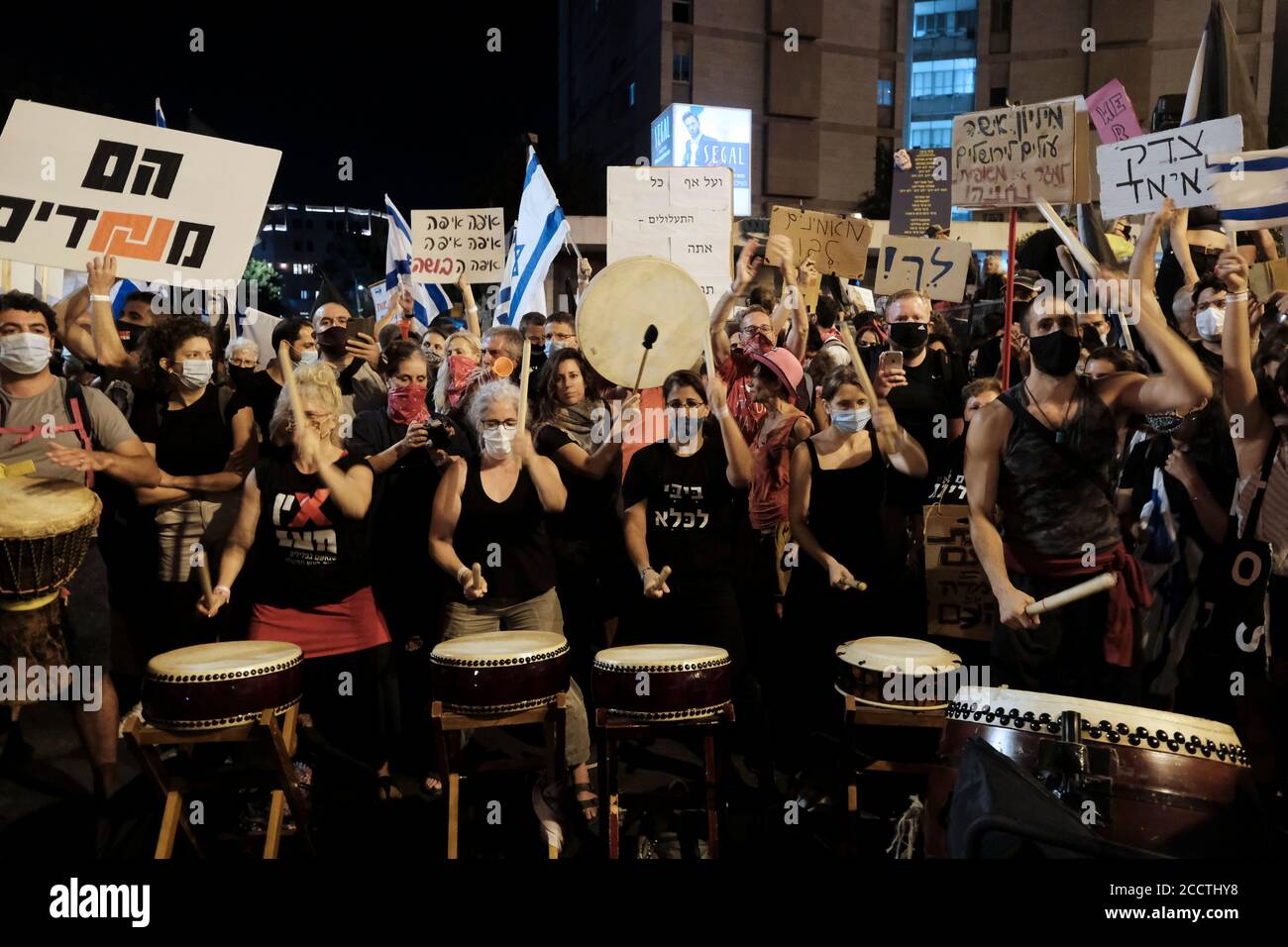 Des manifestants tiennent des pancartes et battent des tambours lors d'une manifestation de masse à laquelle ont assisté plus de 10000 personnes dans le cadre de manifestations en cours contre le Premier ministre Benjamin Netanyahu au sujet de son inculpation pour corruption et manipulation de la pandémie du coronavirus près de la résidence officielle du Premier ministre le 22 août 2020 à Jérusalem, Israël Banque D'Images