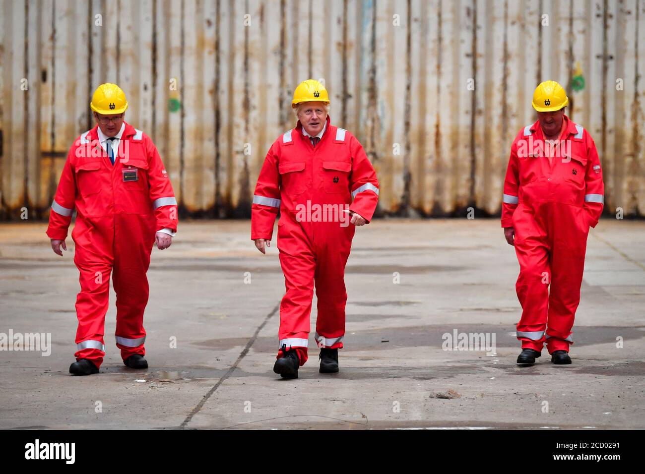 Le Premier ministre Boris Johnson marche sur le quai sec avec le PDG InfraStrata John Wood, à gauche, et le gardien Clifford Edwards, à droite, lors de sa visite au chantier naval Appledore de Devon, qui a été acheté par InfraStrata, la société qui possède également Harland & Wolff (H&W) de Belfast, dans un contrat de 7 millions de livres sterling. Banque D'Images