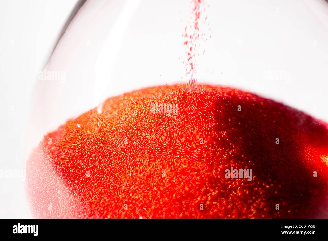 hourglass au sable rouge utilisé pour mesurer le flux temporel, la macro photographie Banque D'Images