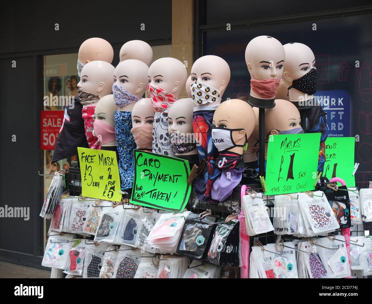 Marché de rue stalle avec des têtes de mannequin vendant une variété de revêtements de visage et de masques pour protéger contre la propagation du coronavirus à York, Royaume-Uni Banque D'Images