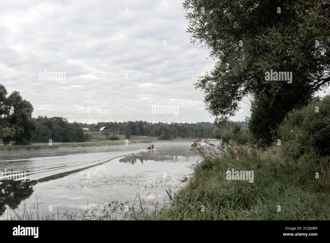 Des hommes naviguent sur un bateau à moteur sur la rivière de Moscou tôt le matin Banque D'Images