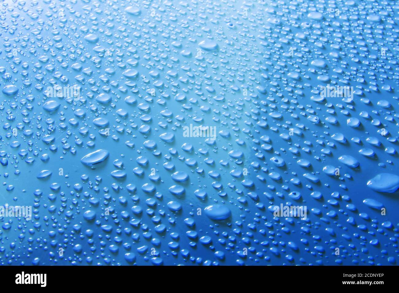 Goutte d'eau sur une surface bleue Banque D'Images