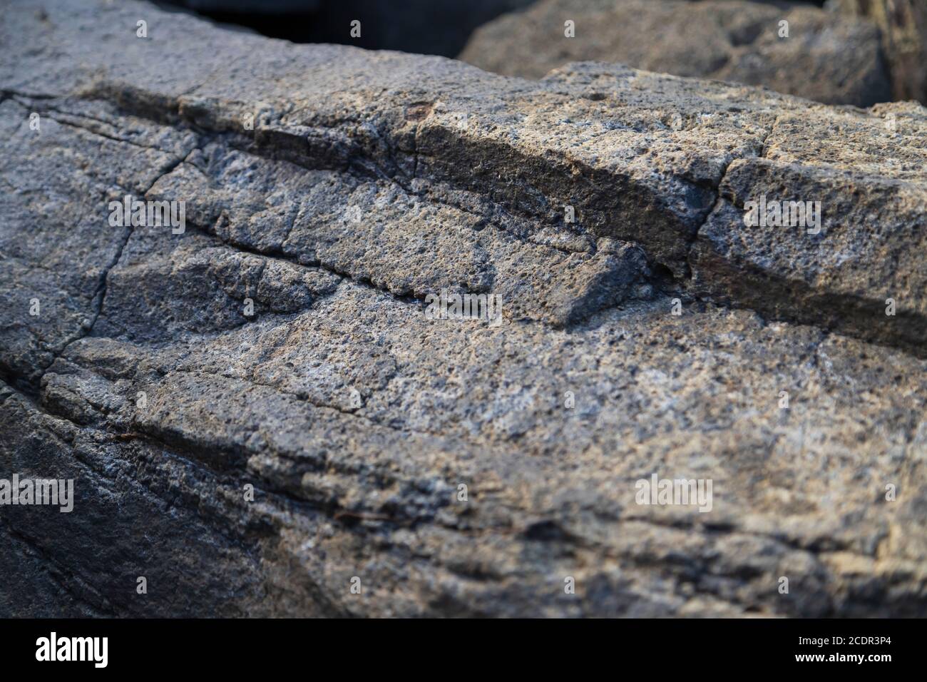 surface d'une roche de près avec des couches et des fissures indiquant où la roche finira par se désintégrer en petits morceaux Banque D'Images