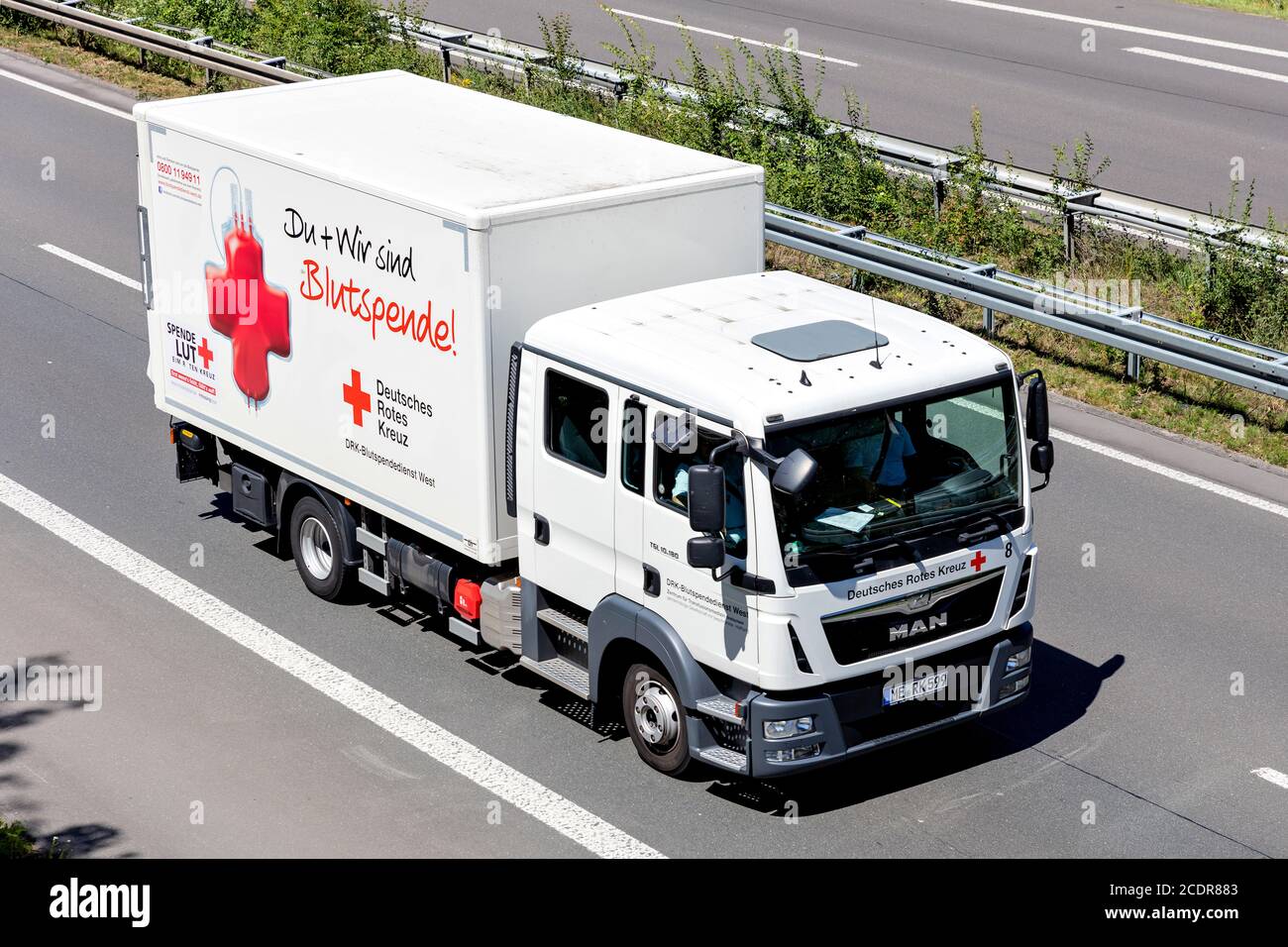 Camion allemand Red MAN TGL sur autoroute. La Croix-Rouge allemande, ou DRK, est la Société nationale de la Croix-Rouge en Allemagne. Banque D'Images