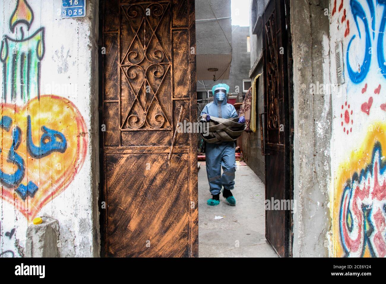 30 août 2020 : Gaza, Palestine. 30 août 2020. Les équipes palestiniennes de défense civile livrent de l'eau potable aux foyers des résidents du camp de réfugiés de Jabalia infectés par le coronavirus, car ils restent en quarantaine et ne peuvent pas récupérer de l'eau potable. Depuis que les premiers cas de coronavirus ont été détectés dans la communauté de Gaza au début de la semaine dernière, le nombre de personnes infectées a régulièrement augmenté à plus de 180 dans l'enclave palestinienne assiégée et densément peuplée. La crise aigue de l'eau dans la bande, où plus de 95 pour cent de l'eau douce ne convient pas à la consommation humaine, met en évidence le déjà grave Banque D'Images
