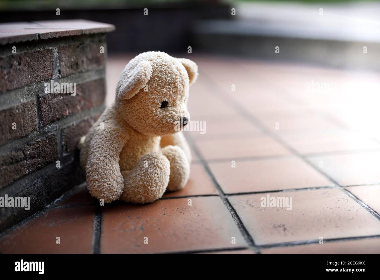 Triste ours en peluche assis sur le sol, traumatisme de l'enfance, abus Banque D'Images