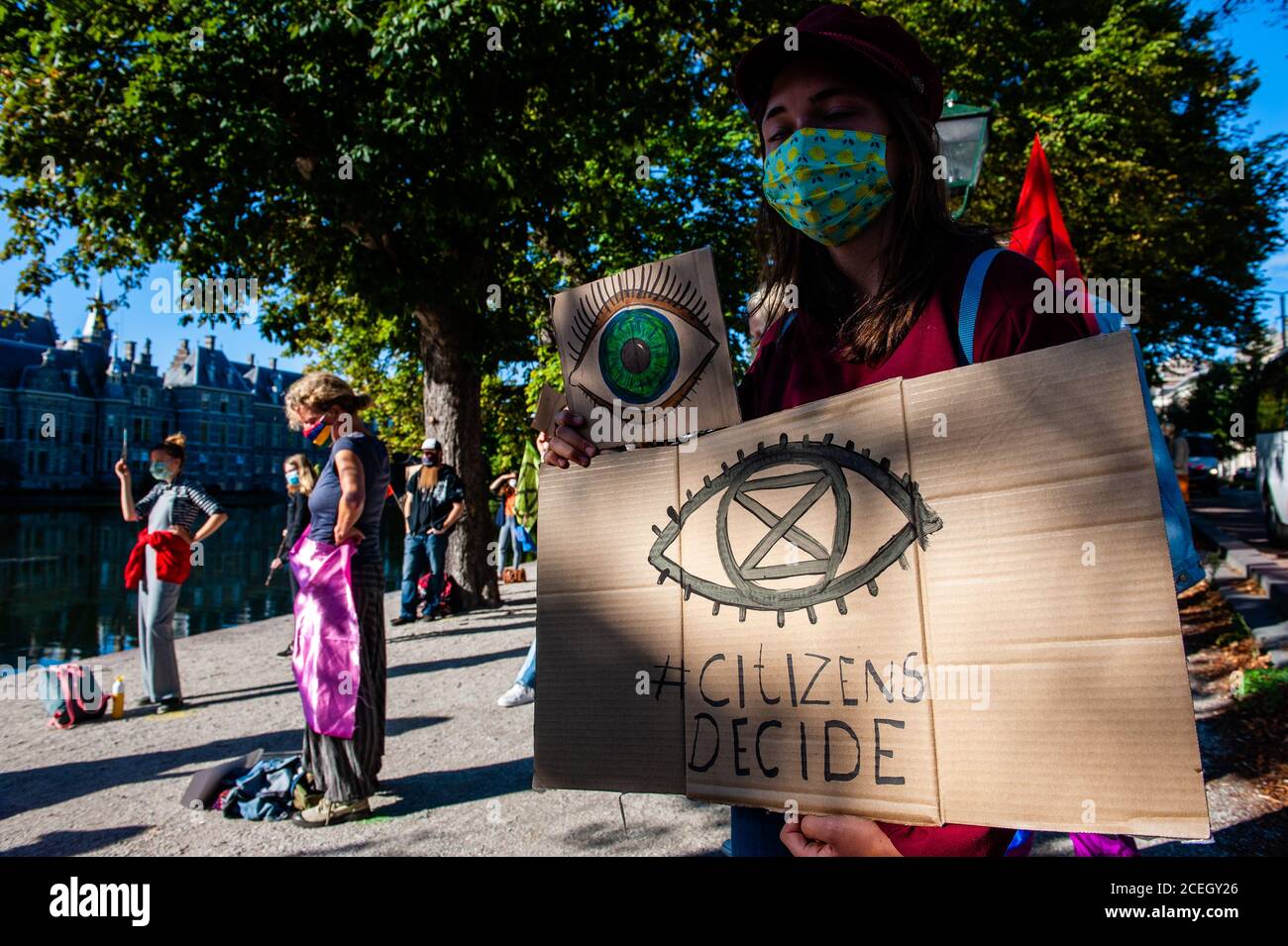 Une femme portant un écriteau sur le climat avec un regard sur celui-ci pendant la manifestation.le groupe d'activistes du climat, la rébellion des extinction aux pays-Bas, a planifié une nouvelle campagne appelée « rébellion des membres » pour attirer l'attention sur la crise climatique et écologique. Les actions débuteront à la Haye et, plus tard ce mois-ci, se poursuivront à Amsterdam. En raison d'un grand nombre d'enregistrements, la manifestation juridique a été déplacée à la Hofvijver, près de la place où se trouve la Chambre du Parlement. Ici, des centaines de militants du XR ont manifesté pacifiquement avec des discours de plusieurs groupes climatiques, dem Banque D'Images