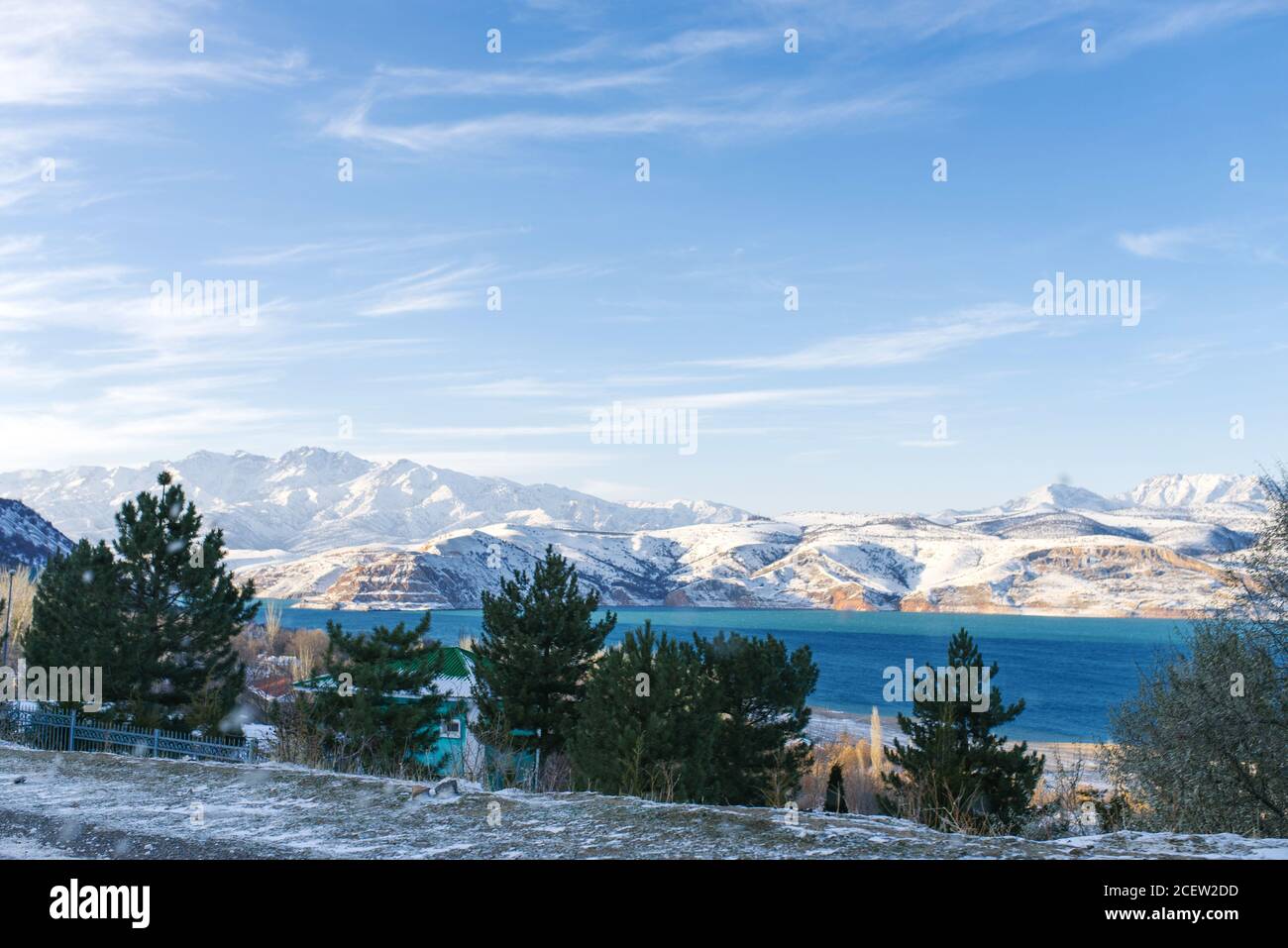 Lac de montagne Charvak en Ouzbékistan par une journée enneigée, entouré par les montagnes Tien Shan. Pyramides de Chimgan Banque D'Images