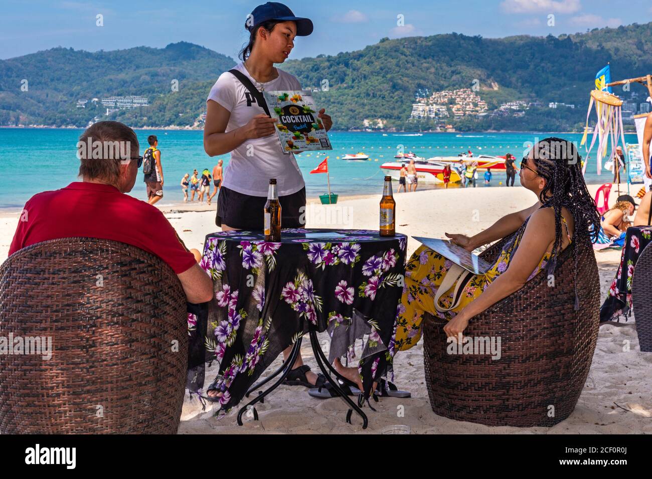 Serveuse et clients au bar de la plage, Patong, Phuket, Thaïlande Banque D'Images