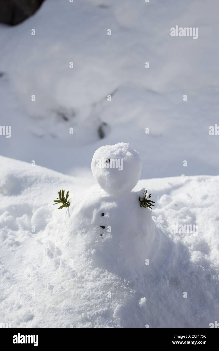 Charmant petit bonhomme de neige avec la main faite de feuilles Banque D'Images