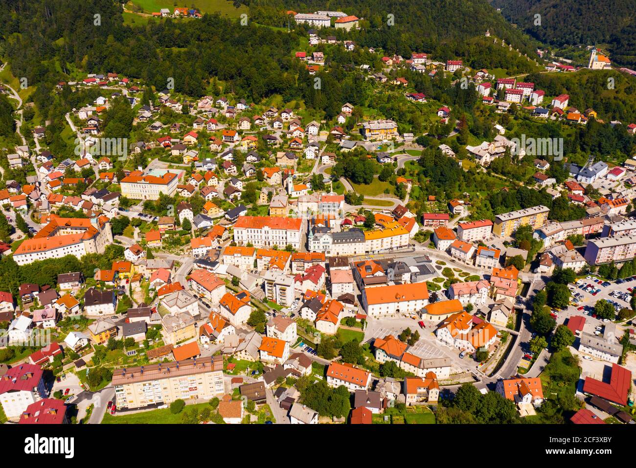 Vue aérienne générale de la petite ville d'Idrija entre vert Collines dans l'ouest de la Slovénie par beau temps Banque D'Images