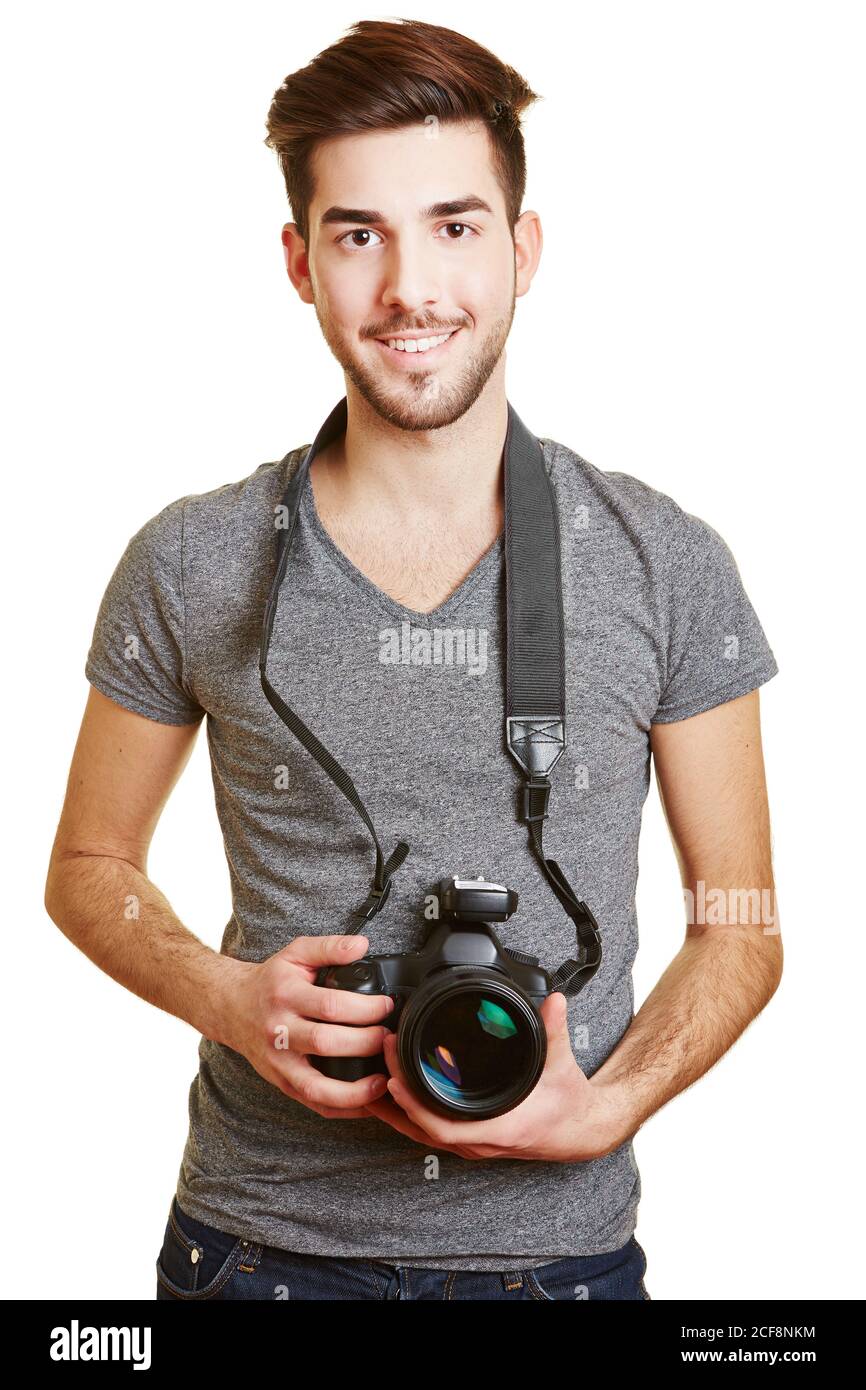 Jeune homme souriant tient une caméra avec déclenchement radio comme un photographe Banque D'Images