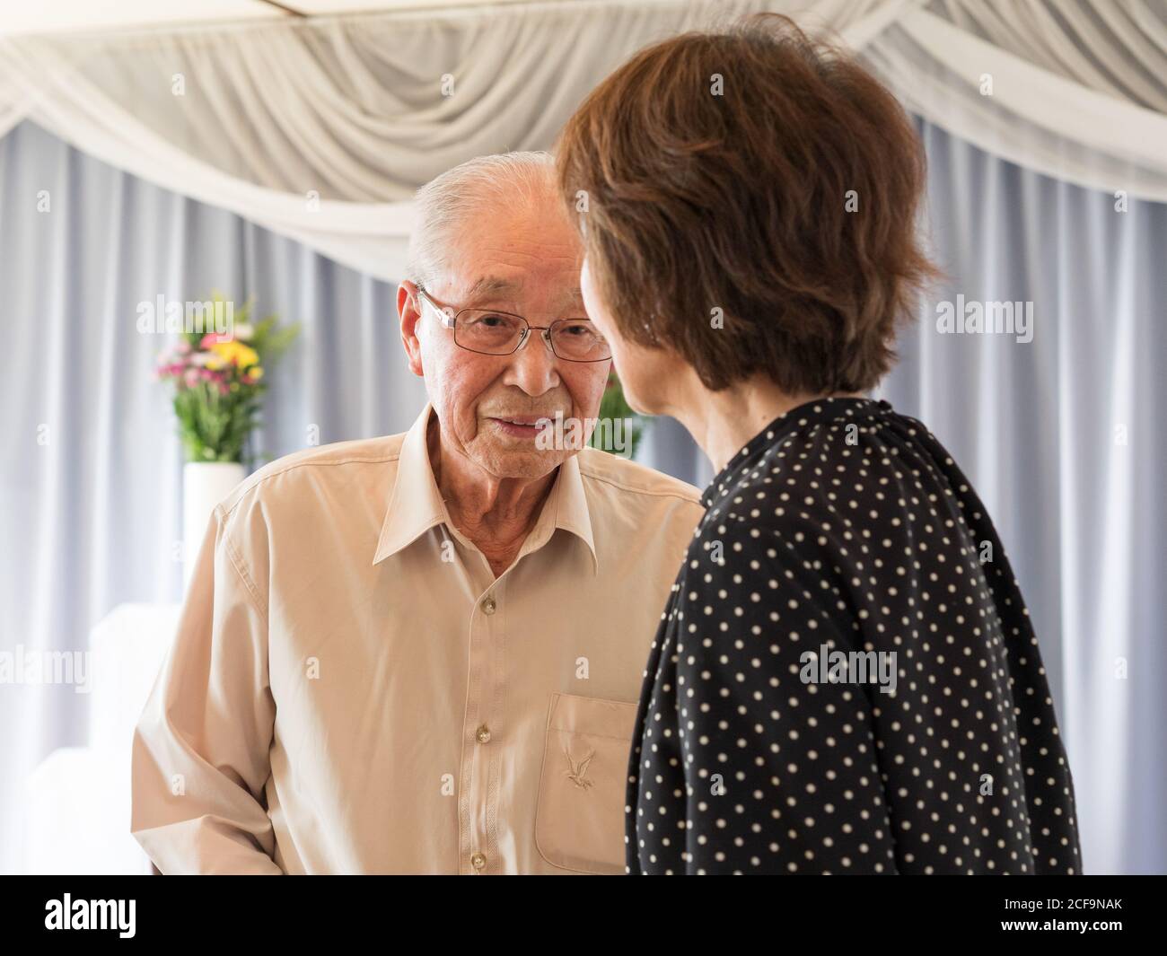 Un vieil homme parlant à sa fille adulte Banque D'Images