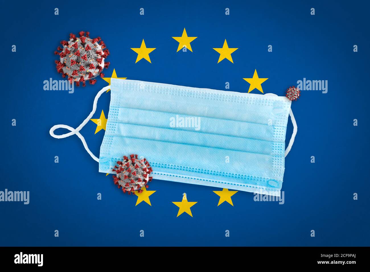Concept de particules coronavirus ou Covid-19 et masque chirurgical sur le drapeau de l'Union européenne en arrière-plan. Banque D'Images