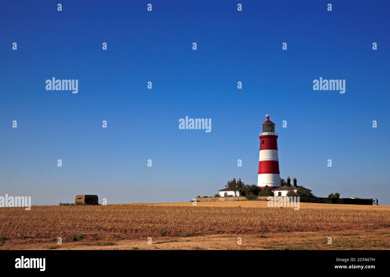 Vue sur le phare et la boîte Pill de la Seconde Guerre mondiale depuis le chemin du sommet de la falaise dans le nord de Norfolk à Happisburgh, Norfolk, Angleterre, Royaume-Uni. Banque D'Images