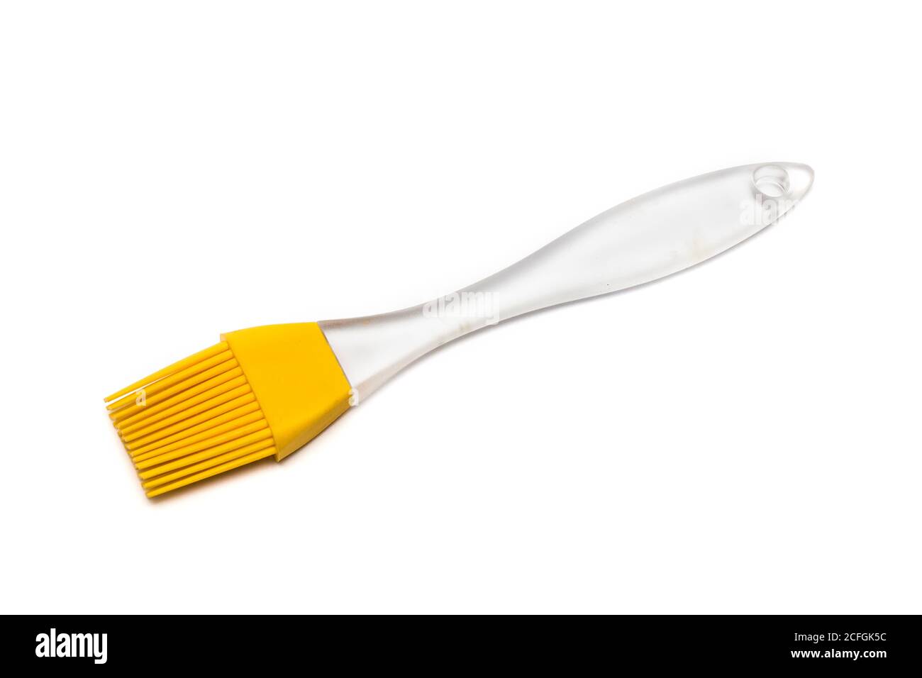 Brosse en silicone jaune avec poignée transparente Banque D'Images