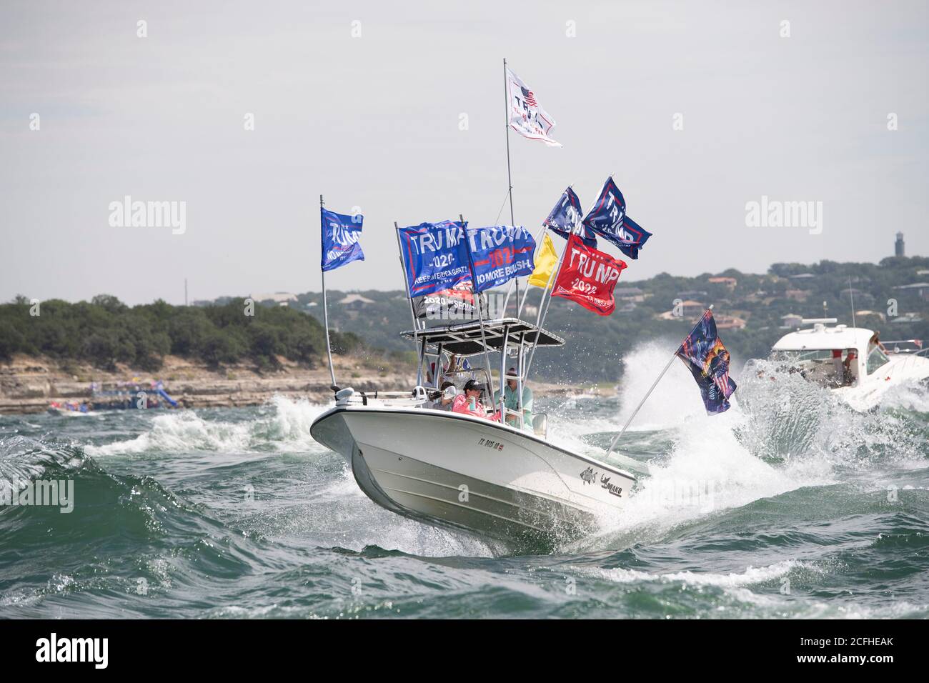 Lakeway, Texas États-Unis 5 septembre 2020 : les drapeaux de Trump volent à travers des vagues extrêmement lourdes remuées par des bateaux à proximité lors d'une parade de bateau pour montrer le soutien à l'US Presd Donald Trump. Le week-end de la fête du travail sur un lac du Texas central a attiré des centaines de motomarines de toutes tailles. Plusieurs bateaux ont été submergés dans les énormes ébarges qui ont été piétinés par la flottille, mais aucune blessure n'a été signalée. Crédit : ©Bob Daemmrich/Alamy Live News Banque D'Images