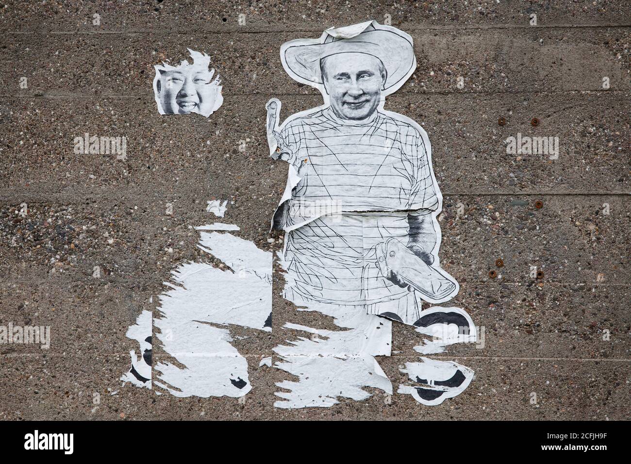 Reste d'une affiche avec Kim Jong-un et Vladimir Poutine sur un mur dans le district de Deutz, Cologne, Allemagne. Reste eines Plakats mit Kim Jong-un und WL Banque D'Images