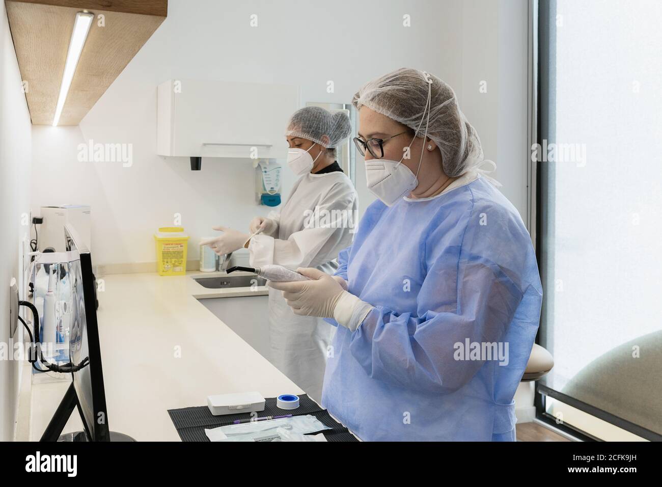 Femmes travailleurs médicaux avec masques de protection pour le visage en se préparant pour procédure médicale à l'hôpital Banque D'Images