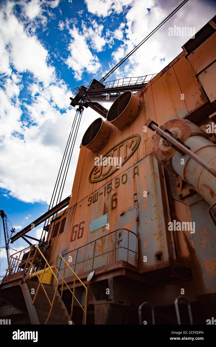 Exploitation et transport du minerai d'aluminium. Mine d'argile de bauxite. Gros plan de la pelle hydraulique à benne traînante. Sur un ciel bleu avec des nuages. Banque D'Images