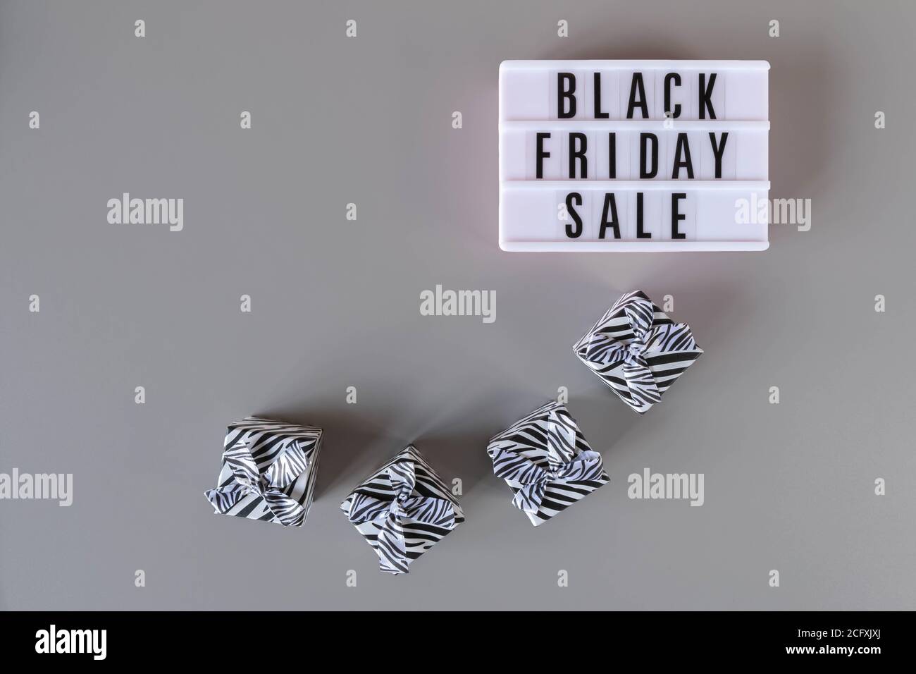 Texte des soldes du Vendredi fou sur une visionneuse blanche et boîtes-cadeaux sur fond gris. Affiche du Vendredi fou avec espace pour les copies. Promotion de Thanksgiving Banque D'Images