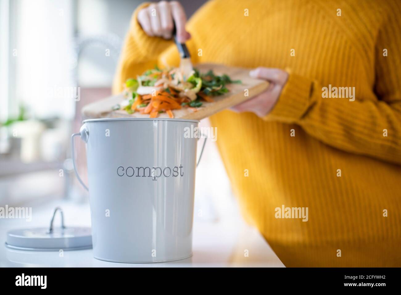 Close Up of Woman Fabriquer du compost à partir de restes de légumes dans la cuisine Banque D'Images