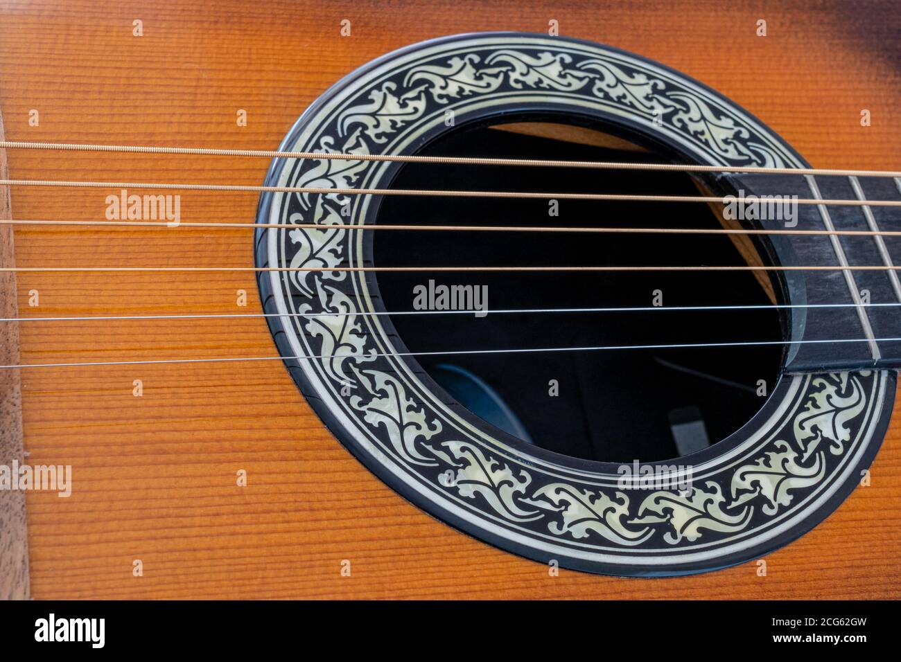 gros plan du trou acoustique de guitare à six cordes et Cordes en bronze phosphoreux Banque D'Images