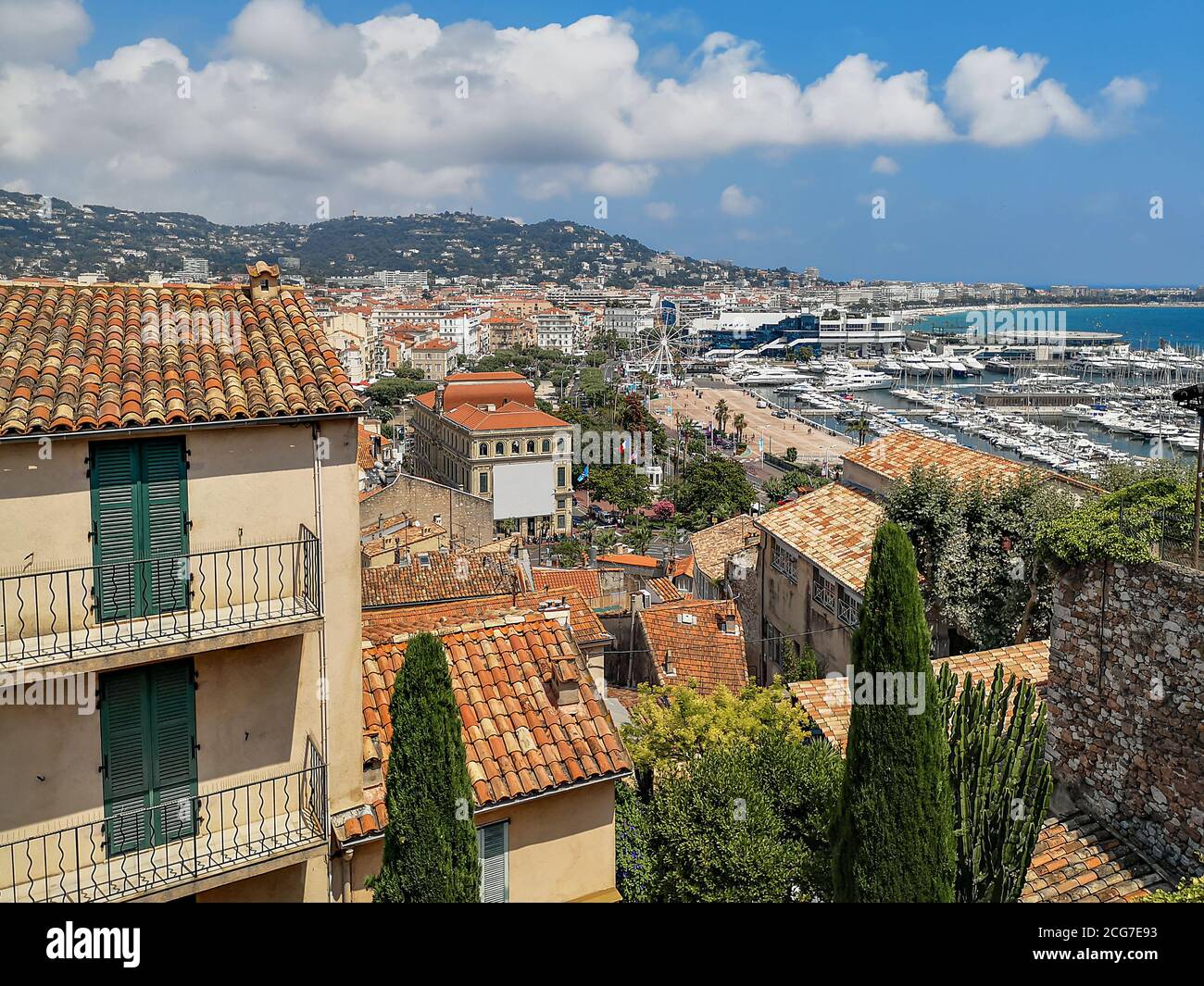 Vue panoramique sur la ville de Nice avec des maisons traditionnelles avec des toits de tuiles rouges, mer Méditerranée avec yachts dans le port, roue d'observation. Banque D'Images