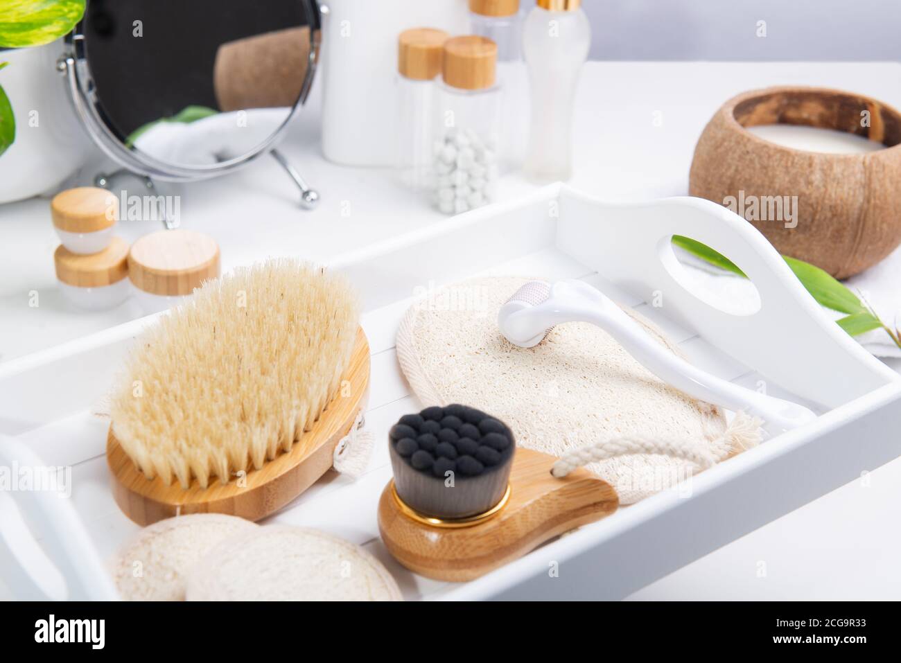 Massage sec de drainage lymphatique brosses en bois, éliminer mezoroller et loofah coussins pour les soins du visage et du corps sur un plateau blanc. Soins de salle de bains. Accueil Banque D'Images