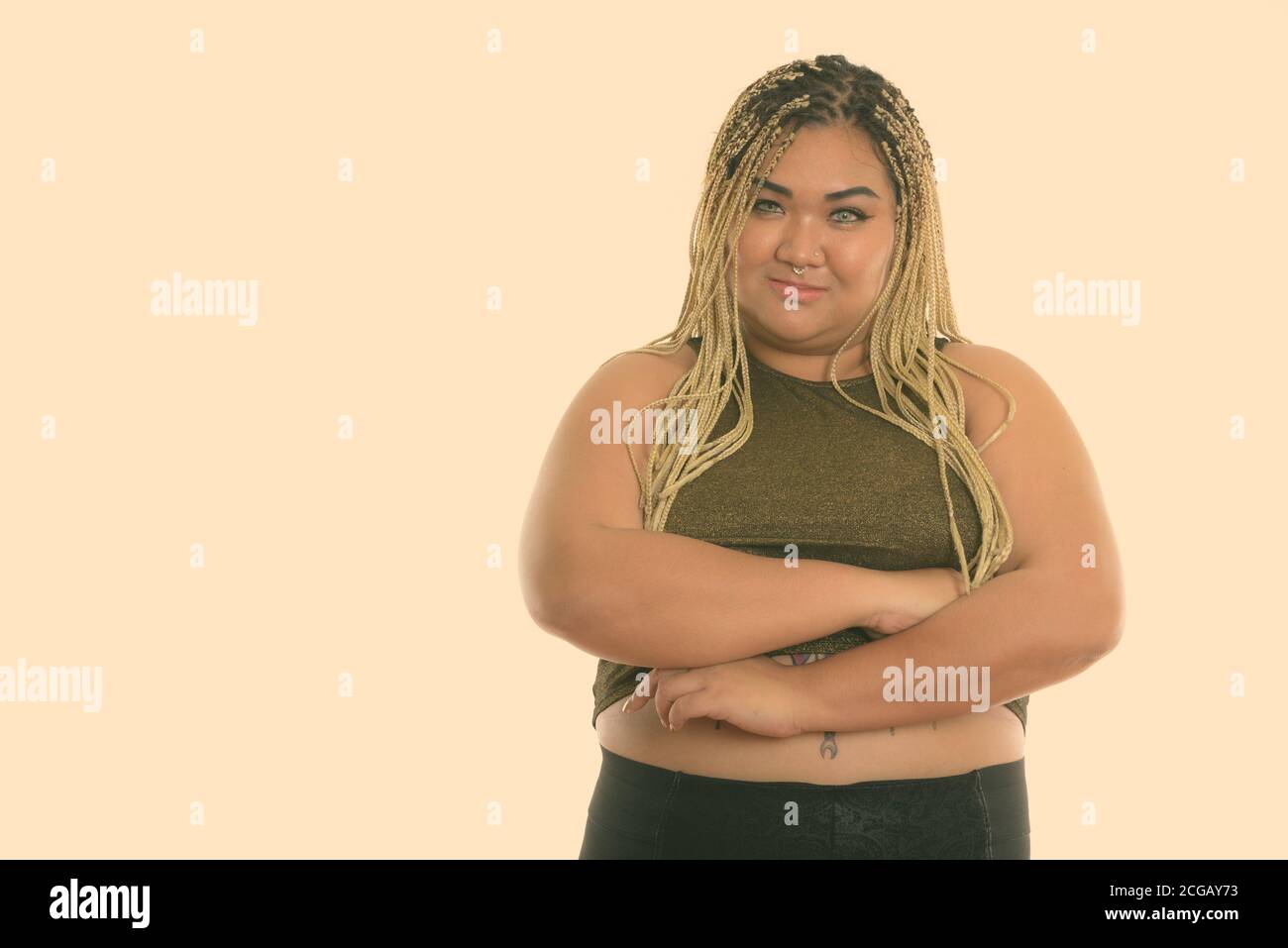 Studio shot of young Asian fat woman with arms crossed Banque D'Images