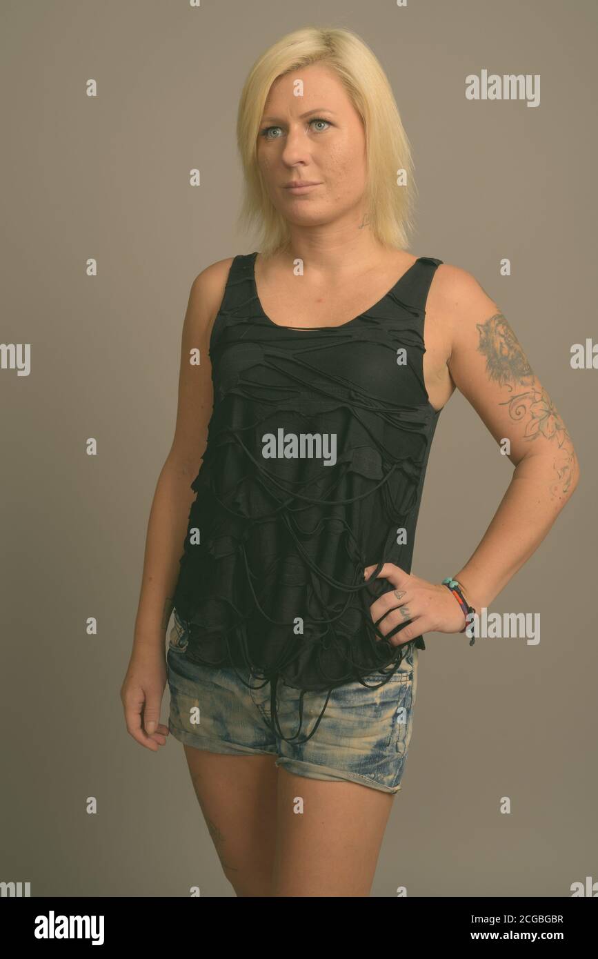 Femme aux cheveux blonds sur fond gris Banque D'Images