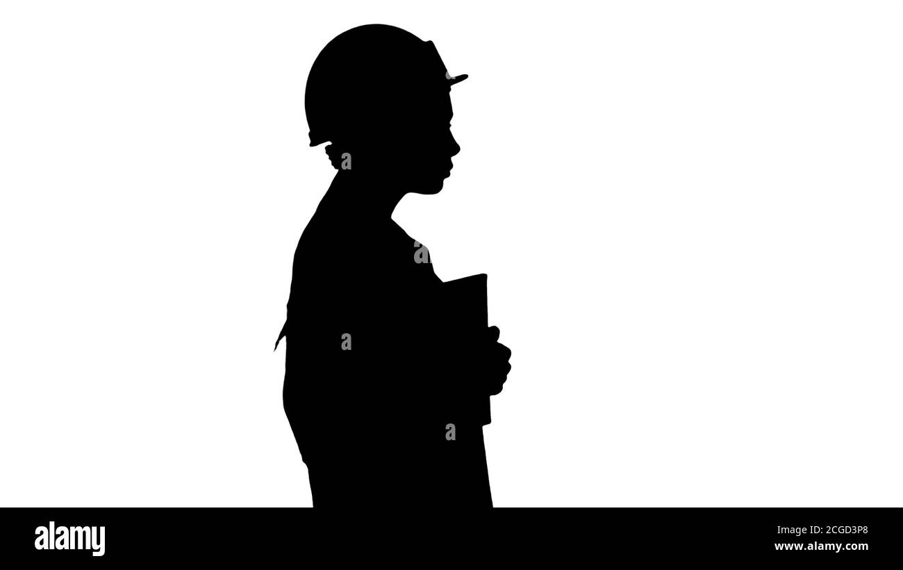 Belle silhouette femme hispanique en sarrau blanc et blanc casque walking holding portable ou tablette. Banque D'Images