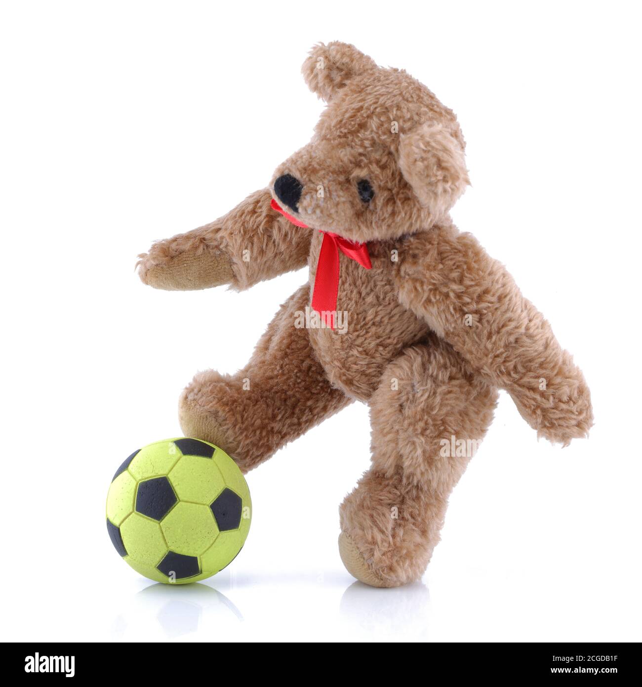 Ours en peluche jouant au football sur fond blanc Banque D'Images