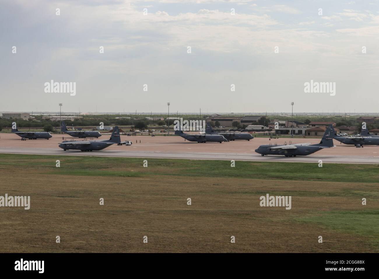 Une ligne d'avions C-130J Super Hercules provenant du 317e taxi de l'aile Airlift sur la piste lors d'un grand exercice de force à la base aérienne de Dyess, Texas, le 14 juillet 2020. L'exercice consistait en 33 avions de la 317e AW et de la 19e AW de Little Rock AFB, Arkansas. Le scénario a permis aux équipages des deux ailes de s’entraîner et de présenter les avantages de la nouvelle initiative de déploiement C-130 “4/12” mise en œuvre en 2019. (É.-U. Photo de la Force aérienne par le sergent d'état-major. David Owsianka) Banque D'Images
