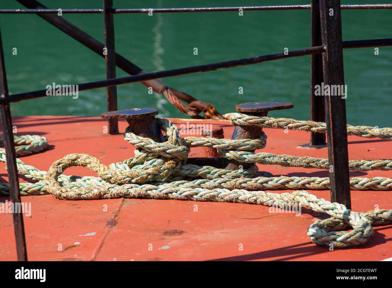 Des cordes de bateau attachées autour d'un va-et-barrique sur le pont d'un bateau de pêche Banque D'Images