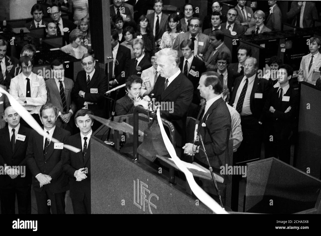 Le gouverneur de la Banque d'Angleterre, Gordon Richardson (cheveux de foire, au centre), coupant la bande pour ouvrir officiellement la London International Financial futures Exchange à la Royal Exchange de Londres. Banque D'Images