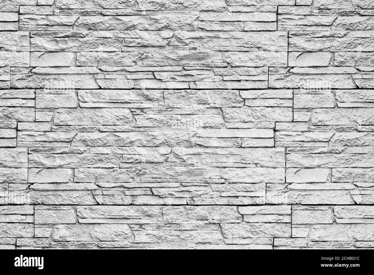 Texture noire et blanche d'un mur recouvert de tuiles décoratives en brique. Arrière-plan monochrome abstrait pour la conception. Banque D'Images