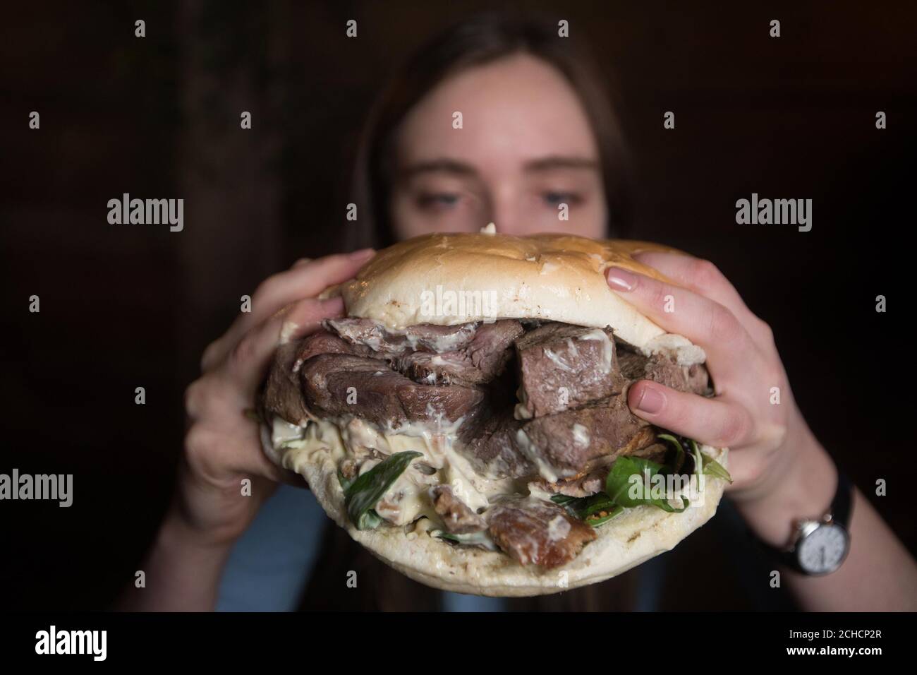 Fiona Gray fait la cuisine d'un hamburger géant dans un restaurant pop-up de Londres appelé Monster Hunter Meat Shack pour célébrer la sortie du prochain jeu vidéo Capcom ÔMonster Hunter:World. ASSOCIATION DE PRESSE. Photo. Date de la photo: Mercredi 24 janvier 2018. Les visiteurs peuvent s'immerger dans le monde mythique du jeu en jouant une version de démonstration sur les consoles de jeu, en mangeant à partir d'une grande broche de viande et en saluant un personnage de créature dragon appelé ÔRathalos'. Le crédit photo devrait se lire: David Parry/PA Wire Banque D'Images