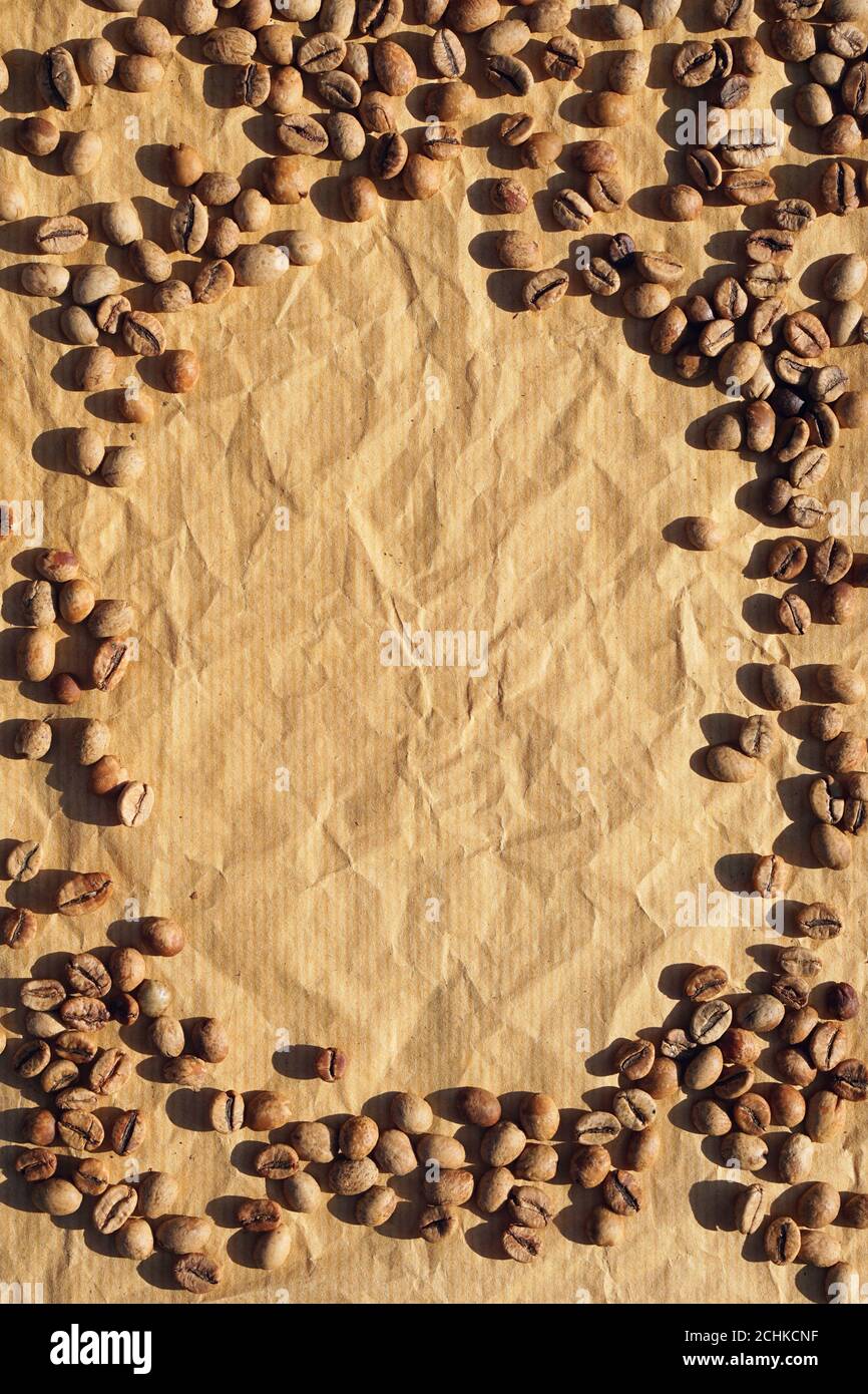 Arrière-plan de grains de café bruns sur papier artisanal comme arrière-plan avec ombre Banque D'Images