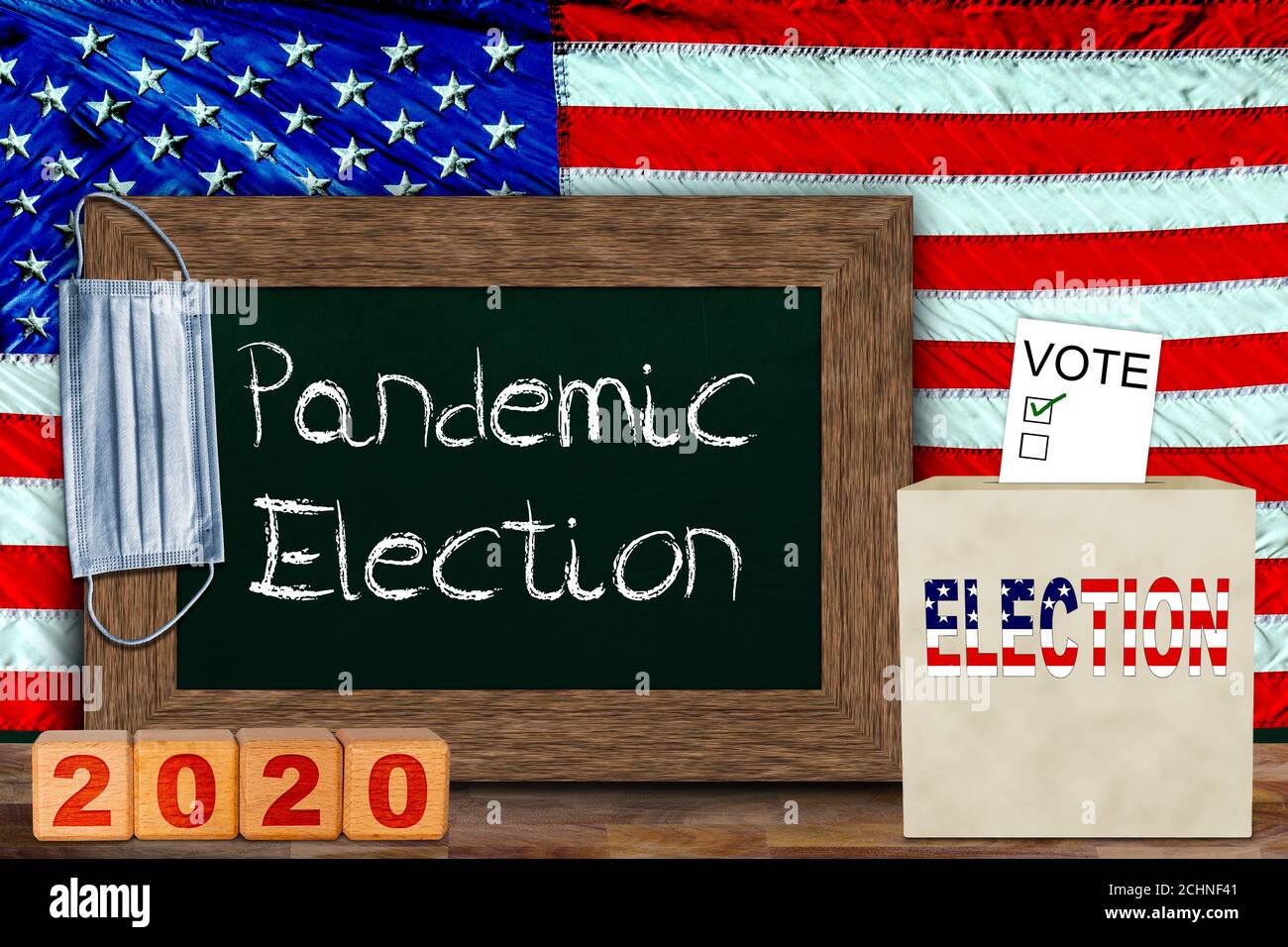 CONCEPT DES élections pandémiques AMÉRICAINES avec drapeau américain accroché derrière un tableau noir en bois pour la copie, et boîte de vote avec bulletin de vote. Concept de votant Banque D'Images