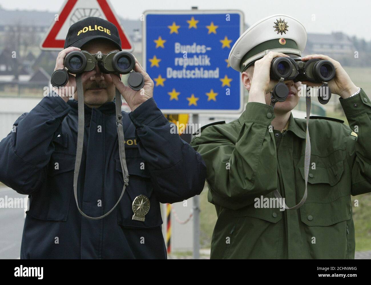 CZECH REPUBLIC AND GERMAN BORDER POLICE OFFICERS OBSERVE WITH THEIR  BINOCULARS THE GERMAN-CZECH UNGUARDED BORDER ZONE NEAR GERMAN VILLAGE OF  ZINNWALD. Petr Wolf (L) a Czech Republic border police officer and his