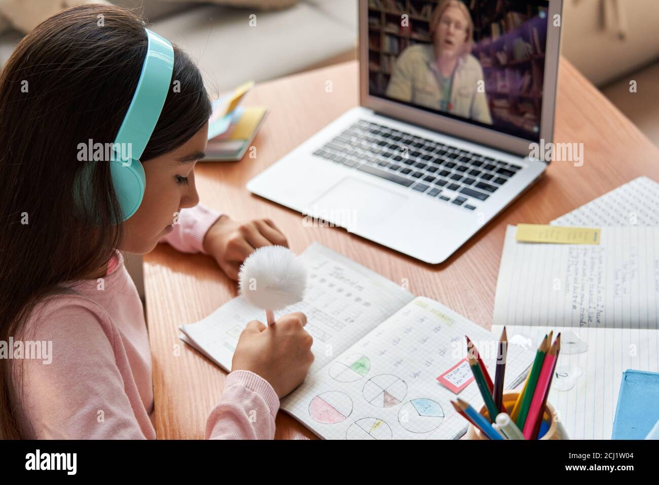 École indienne fille apprendre en ligne vidéo appelant professeur de mathématiques, au-dessus de l'épaule. Banque D'Images